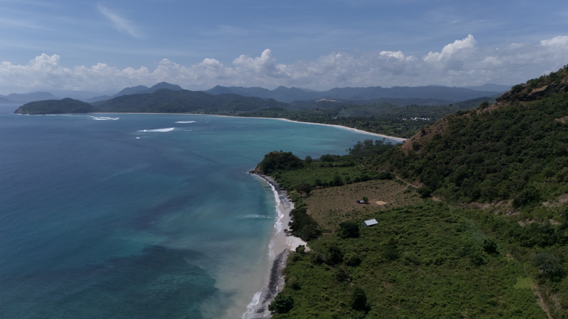 Aerial overview of the beachfront Sumbawa land and bay